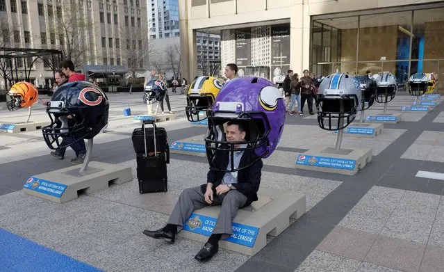 Oversized NFL football helmets are displayed in Pioneer Court Wednesday, April 15, 2015, in downtown Chicago, as the city prepares to host the NFL draft from April 30 to May 2. (Photo by Kiichiro Sato/AP Photo)