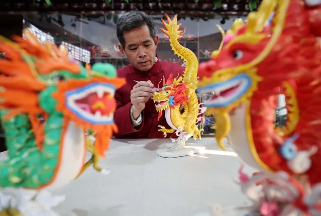 Folk artist Zuo Ansheng creates dragon-shaped dough models at an intangible cultural heritage museum on December 26, 2023 in Linyi, Shandong Province of China. The upcoming year is the year of the dragon according to Chinese zodiac. (Photo by Wang Yanbing/VCG via Getty Images)