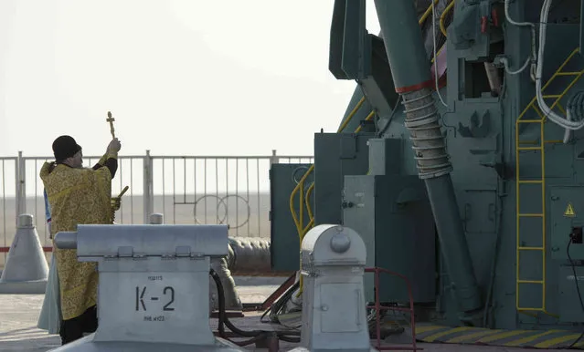 Russian Orthodox Priest Father Sergei blesses the Soyuz rocket at the Baikonur Cosmodrome launch pad, Thursday, March 14, 2019 in Baikonur, Kazakhstan. The new Soyuz mission to the International Space Station (ISS) is scheduled on Thursday, March 14 with U.S. astronauts Christina Hammock Koch, Nick Hague, and Russian cosmonaut Alexey Ovchinin. (Photo by Bill Ingalls/NASA via AP Photo)