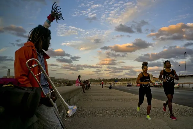In this January 30, 2017 photo, boxers Idamerys Moreno, second right, and Legnis Cala, right, run along Havana's Malecon, in Cuba. Moreno and Cala are part of a group of up-and-coming female boxers on the island who want government support to form Cuba's first female boxing team and help dispel a decades-old belief once summed up by a former top coach: “Cuban women are meant to show the beauty of their face, not receive punches”. (Photo by Ramon Espinosa/AP Photo)