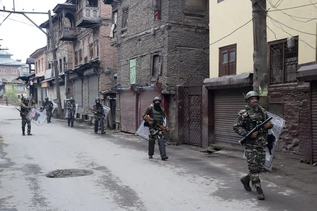 Indian paramilitary soldiers patrol a deserted street during the second phase of India's general elections, in Srinagar, Indian controlled Kashmir, Thursday, April 18, 2019. Kashmiri separatist leaders who challenge India's sovereignty over the disputed region have called for a boycott of the vote. Most polling stations in Srinagar and Budgam areas of Kashmir looked deserted in the morning with more armed police, paramilitary soldiers and election staff present than voters. (Photo by Dar Yasin/AP Photo)