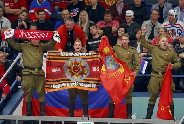 Russia's national ice hockey team supporters wave flags during their ice hockey World Championship game against the U.S. at the CEZ Arena in Ostrava, Czech Republic, May 4, 2015. (Photo by Laszlo Balogh/Reuters)