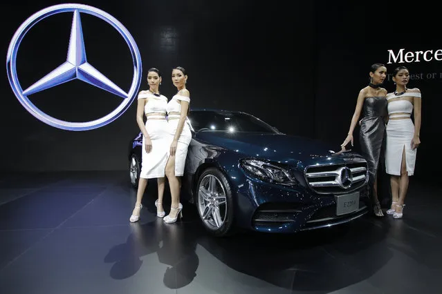 Models pose beside a Mercedes-Benz E220d during a media presentation at the 37th Bangkok International Motor Show in Bangkok, Thailand, March 22, 2016. (Photo by Chaiwat Subprasom/Reuters)