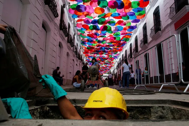 A man works on a decorated street in Caracas, Venezuela on May 10, 2019. (Photo by Ivan Alvarado/Reuters)