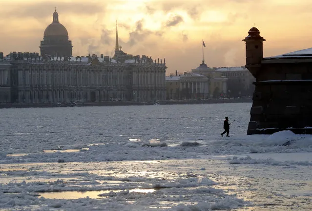 A man makes a selfie near the freezing Neva River with St. Isaac's Cathedral and The Admiralty on the background, during sunset in St. Petersburg, Russia, 02 December 2021. Temperatures dropped to minus ten degrees Celsius in the second largest city of Russia. (Photo by Anatoly Maltsev/EPA/EFE)