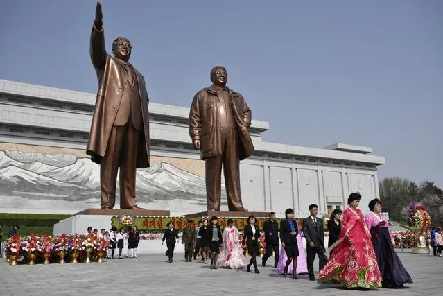 People leave after they paid respect to former leaders Kim Il-sung (L) and Kim Jong-il at Mansu Hill in Pyongyang, North Korea, 15 April 2016. North Korea is marking the “Day of the Sun”, celebrating the day of birth of the country's founder, Kim Il-sung. The Day of the Sun is a national holiday. (Photo by Franck Robichon/EPA)