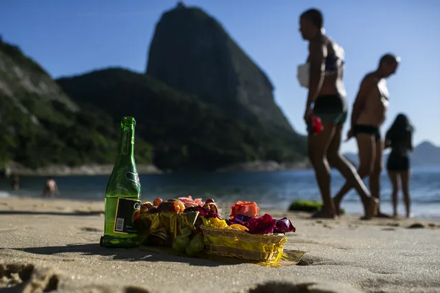 Offerings in honor of the Goddess of the Sea Yemanja sit on Praia Vermelha beach to mark the end of the year in Rio de Janeiro, Brazil, on New Year's Eve, Thursday, December 31, 2020. Beaches will be closed on the night of new years, to help curb the spread of COVID-19. (Photo by Bruna Prado/AP Photo)
