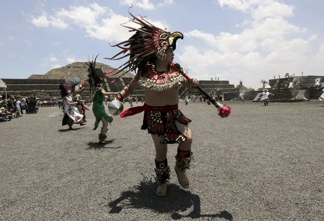 Dancers dressed in prehispanic costumes perform during the Ceremony of the Ignition of the New Fire, at the ancient pyramids of Teotihuacan outside Mexico City May 25, 2015. (Photo by Henry Romero/Reuters)