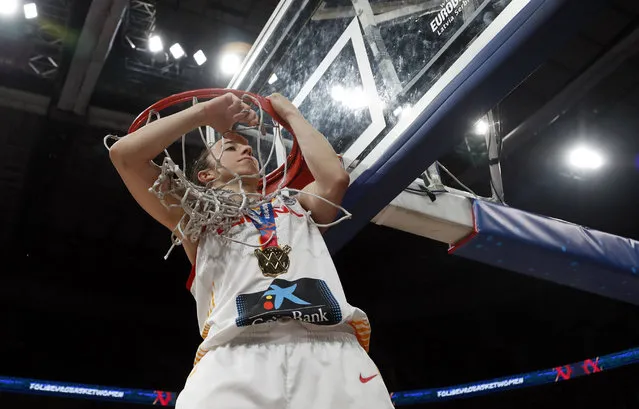 Spain's Silvia Dominguez cuts down the net after the Women's 2019 Eurobasket European Basketball Championship final match between Spain and France in Belgrade, Serbia, Sunday, July 7, 2019. (Photo by Darko Vojinovic/AP Photo)