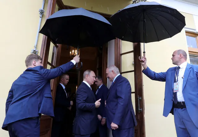 Russian President Vladimir Putin sees Belarus' President Alexander Lukashenko off following their talks in Saint Petersburg on July 18, 2019. (Photo by Mikhail Klimentyev/Sputnik/AFP Photo)