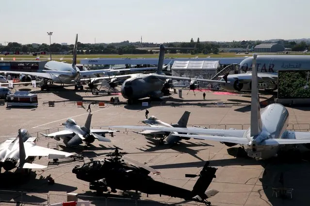 Airplanes are seen on display in the evening at the 51st Paris Air Show at Le Bourget airport near Paris June 16, 2015. Picture taken June 16, 2015. REUTERS/Pascal Rossignol 