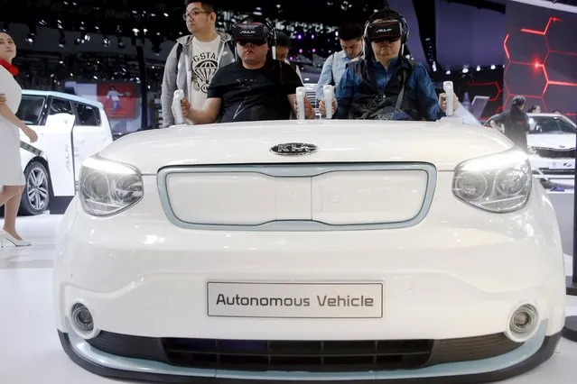 Visitors use VR experience technology at the booth of Kia Motors during the Auto China 2016 auto show in Beijing April 26, 2016. (Photo by Kim Kyung-Hoon/Reuters)