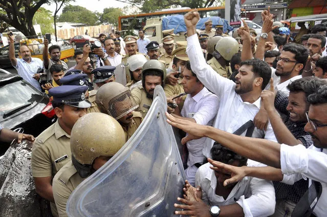 Police stop students who were protesting following the rape and murder of a law student in Kochi, Kerala state, India, Tuesday, May 3, 2016. Police detained three men for questioning Tuesday in the rape and murder of a law student whose body was found mutilated in southern India, officials said.The case has drawn comparisons to the deadly 2012 gang rape of a woman on a New Delhi bus that sparked widespread outrage and nationwide protests demanding an end to the widespread sexual assault and abuse of women across India.(Photo by Press Trust of India via AP Photo)