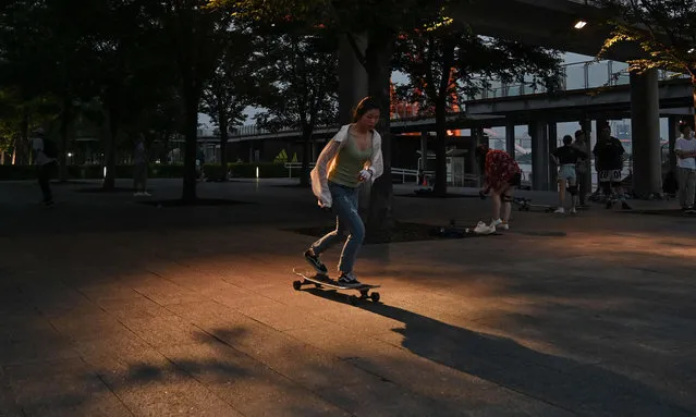 This photo taken on July 14, 2019 shows a young woman skateboarding next to the Shanghai Long Museum in Shanghai. Skateboarding will make its Olympic debut in Tokyo at the 2020 Olympic Games, but many in the growing scene in Shanghai complain that they have few places to go and are looked down upon as trouble-makers. (Photo by Hector Retamal/AFP Photo)