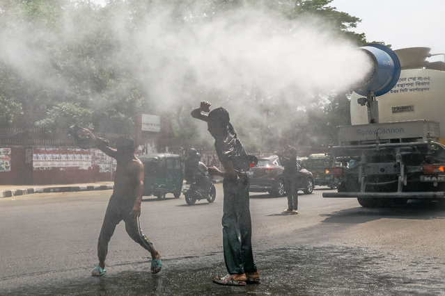A mist cannon is blowing water particles at high speed onto the road to cool the air during the heatwave in Dhaka, Bangladesh, on April 25, 2024. (Photo by Kazi Salahuddin Razu/NurPhoto/Rex Features/Shutterstock)