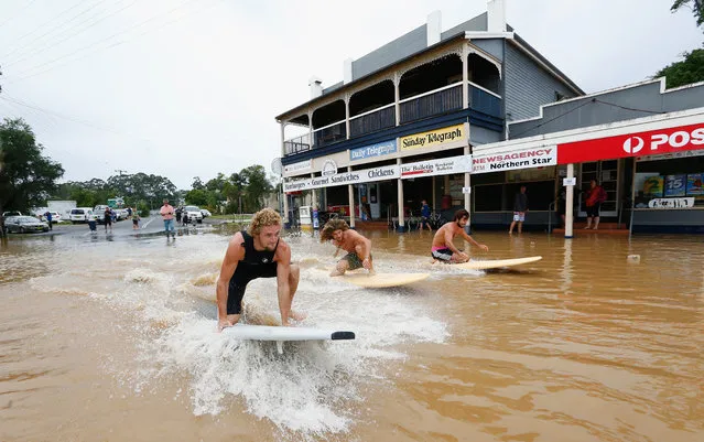 Local residents surf down the main street on March 31, 2017 in Billinudgel, Australia. Heavy rain has caused flash flooding in south east Queensland and Northern New South Wales as as ex-cyclone Debbie makes its way south across the country. Category 4 Cyclone Debbie hit Northern Queensland on Tuesday, causing widespread damage. (Photo by Jason O'Brien/Getty Images)