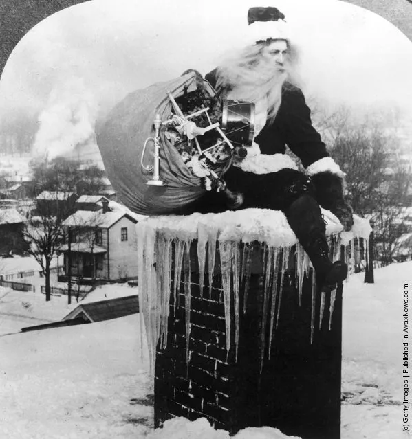 1925: Santa Claus brings a sack full of toys down a chimney on a snowy rooftop