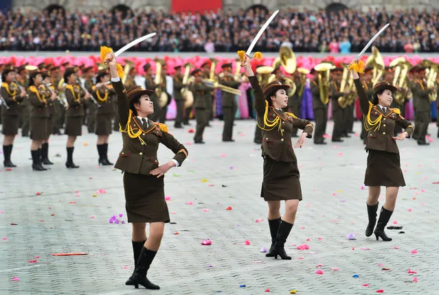 Women dressed in military outfits dance with swords in a parade at Kim Il Sung Square in Pyongyang, North Korea on May 10, 2016. The parade and festivities tonight mark the culmination of the Seventh Congress of the Workers' Party which ended yesterday. The Party cemented Kim Jong Un's leadership and yesterday named him as Party Chairman.   He attended today's parade waving from a balcony to a roaring crowd of worshipers. (Photo by Linda Davidson/The Washington Post)