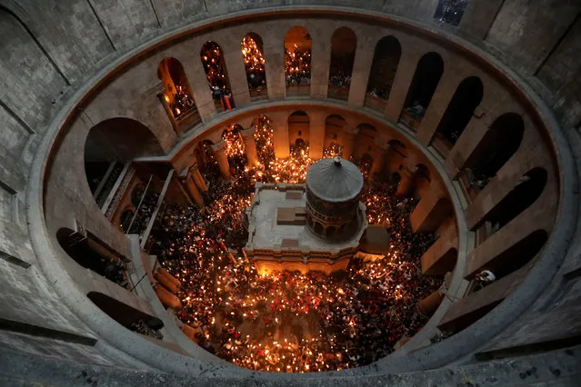 Worshippers hold candles as they take part in the Christian Orthodox Holy Fire ceremony at the Church of the Holy Sepulchre in Jerusalem's Old City April 15, 2017. (Photo by Ammar Awad/Reuters)