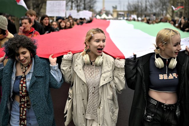 People carry a huge Hungarian flag during a march, marking the 175th anniversary of a failed 1848 uprising, in Budapest, Hungary, Wednesday, March 15, 2023. A “freedom march” was organized by dozens of civic organizations who are calling for greater social solidarity and an end to what they call intimidation from Viktor Orban's government. (Photo by Denes Erdos/AP Photo)