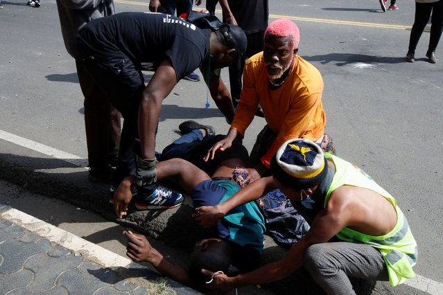 A person is assisted during a demonstration against Kenya's proposed finance bill 2024/2025 in Nairobi, Kenya, on June 25, 2024. (Photo by Monicah Mwangi/Reuters)