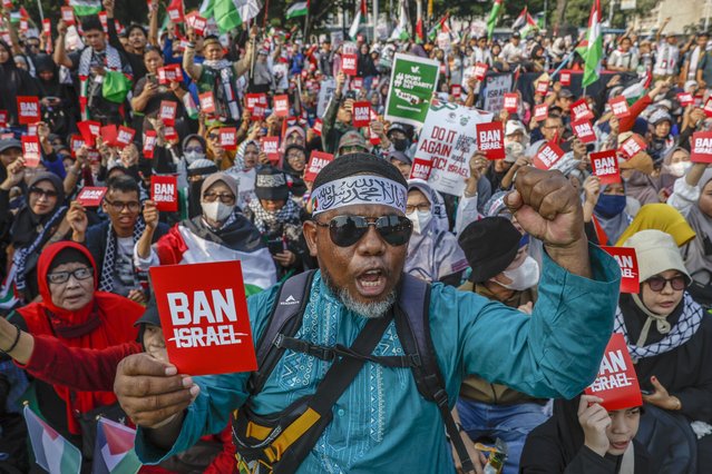 A protester holds a red card during a pro-Palestinian rally in Jakarta, Indonesia, 21 July 2024. Thousands of protesters staged a rally demanding the International Olympic Committee (IOC) to ban Israel from participating in the Olympics in solidarity with the Palestinian people. (Photo by Mast Irham/EPA)