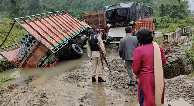 People inspect the area of a landslide after heavy rainfall in Dima Hasao district, in the northeastern Indian state of Assam, Monday, May 16, 2022. At least eight people have died in floods and mudslides triggered by heavy rains in India’s northeast region, officials said Tuesday. (Photo by Dima Hasao district administration via AP Photo)
