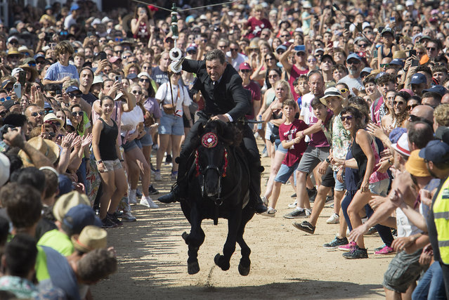 A rider gallops with a lance during the traditional San Juan (Saint John) festival in the town of Ciutadella, on the Balearic Island of Menorca, Spain on June 24, 2023. (Photo by Jaime Reina/AFP Photo)