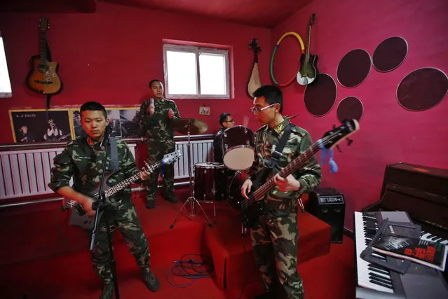 Wang (2nd from L) takes part in a music class as a part of the education program at the Qide Education Center in Beijing February 26, 2014. The Qide Education Center is a military-style boot camp which offers treatment for internet addiction. (Photo by Kim Kyung-Hoon/Reuters)