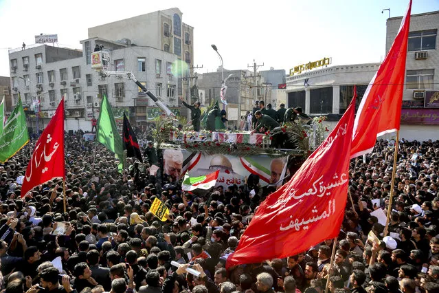 In this photo provided by The Iranian Students News Agency, ISNA, flag draped coffins of Gen. Qassem Soleimani and his comrades who were killed in Iraq in a U.S. drone strike, carried on a truck surrounded by mourners during their funeral in southwestern city of Ahvaz, Iran, Sunday, January 5, 2020. The body of Soleimani arrived Sunday in Iran to throngs of mourners, as U.S. President Donald Trump threatened to bomb 52 sites in the Islamic Republic if Tehran retaliates by attacking Americans. (Photo by Alireza Mohammadi/ISNA via AP Photo)