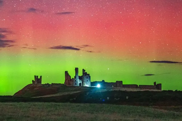 The magical Aurora Borealis seen over Dunstanburgh Castle, Northumberland in North East England on Saturday evening, October 27, 2021. (Photo by Bav Media)