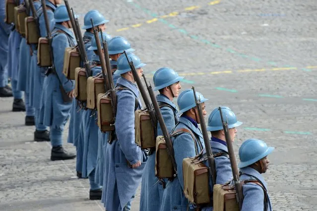 French soldiers wearing WWI French soldiers “Poilu” uniforms parade on the Champs-Elysees during the annual Bastille Day military parade on July 14, 2014 in Paris, France. France has issued an unprecedented invitation to all 72 countries involved in World War I to take part in its annual Bastille Day military parade. (Photo by Antoine Antoniol/Getty Images)