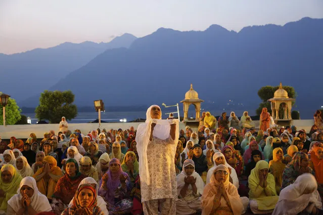 Kashmiri Muslim devotees pray early in the morning at the Hazratbal shrine, during special prayers to observe the Martyr Day of Hazrat Ali, cousin of the Prophet Muhammad, in Srinagar, Indian controlled Kashmir, Monday, June 27, 2016. The festival coincides with the 21st day of the Islamic holy month Ramadan, when devout Muslims refrain from eating, drinking and smoking from dawn to dusk. (Photo by Mukhtar Khan/AP Photo)