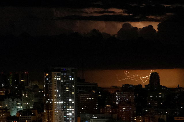 A flash from the lightning illuminates the sky over the city before a night storm in Kyiv, Ukraine on June 4, 2024. (Photo by Gleb Garanich/Reuters)