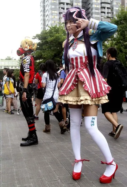 Participants wearing costumes featuring from animations at the Taipei Comics Festival in Taipei, Taiwan, Saturday, July 26, 2014. (Photo by Chiang Ying-ying/AP Photo)