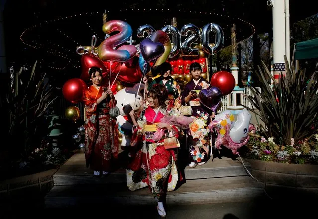 Japanese women wearing kimonos hold balloons as they attend their Coming of Age Day celebration ceremony at Toshimaen amusement park in Tokyo, Japan, January 13, 2020. (Photo by Kim Kyung-Hoon/Reuters)