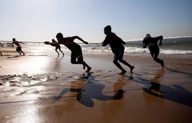 Fishermen pull in nets during the annual sardine run, in Winklespruit, near Durban, South Africa on July 1, 2022. (Photo by Rogan Ward/Reuters)