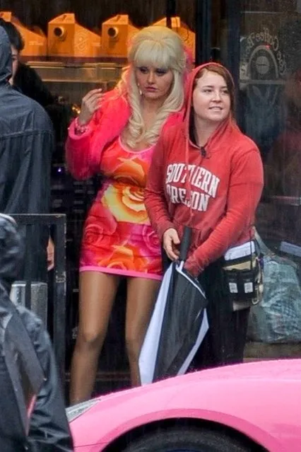 Emmy Rossum steps into character on the set of “Angelyne” on a rainy day in Los Angeles on March 12, 2020. The actress and crew take a break from filming at The Coffee Bean & Tea Leaf as the rain comes down. Emmy can be seen chatting with her body double before getting back to work. (Photo by Backgrid USA)