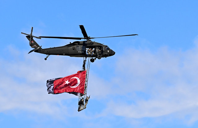 Police special operations teams perform with a helicopter during Turkiye's premier technology and aerospace event TEKNOFEST on its first day at Adana Airport in Adana, Turkiye on October 02, 2024. The four-day event will feature competitions, air shows, exhibitions and workshops. The event has been organized by the Turkish Technology Team (T3) Foundation and the Turkish Industry and Technology Ministry jointly since 2018, in cooperation with dozens of ministries, public institutions, private firms, and universities. (Photo by Utku Ucrak/Anadolu via Getty Images)