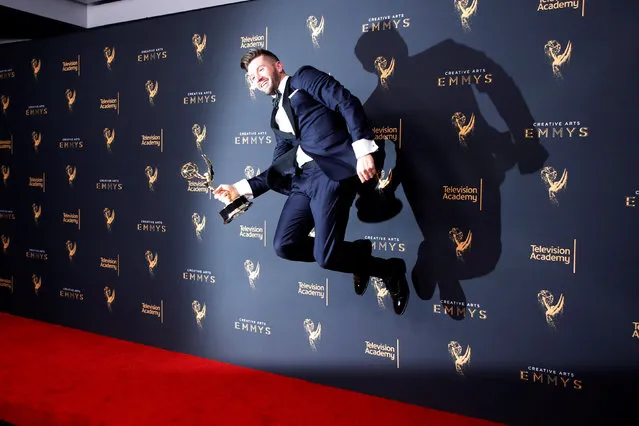 Choreographer Travis Wall jumps as he poses with his Outstanding Choreography Emmy Award for “So You Think You Can Dance” backstage at the 2017 Creative Arts Emmy Awards in Los Angeles, California, U.S. September 9, 2017. (Photo by Danny Moloshok/Reuters)