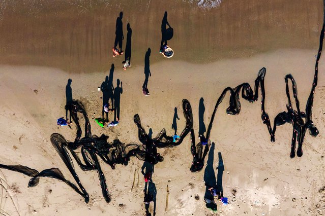 An aerial picture shows fishermen arranging nets at a beach in Banda Aceh on January 2, 2025. (Photo by Chaideer Mahyuddin/AFP Photo)