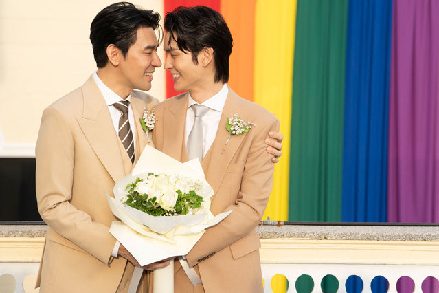 Thai actors Apiwat “Porsch” Apiwatsayree (L) and Sappanyoo “Arm” Panatkool pose for pictures after registering their same-sеx marriage at the Phra Nakhon district office in Bangkok on January 23, 2025. A high-profile gay couple married in Thailand on January 23 as the kingdom's same-s*x marriage law went into effect, an AFP journalist saw, among the first of hundreds expected to do so. (Photo by Chanakarn Laosarakham/AFP Photo)