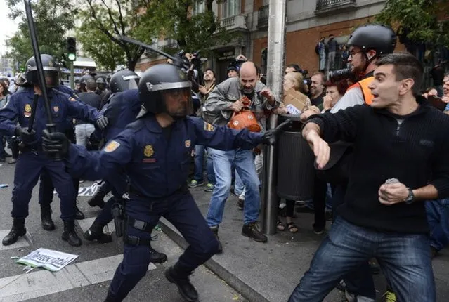 Protesters clash with riot policemen during a demonstration organized by Spain's "indignant" protesters to decry an economic crisis they say has "kidnapped" democracy, on September 25, 2012 in Madrid. Spanish riot police fired rubber bullets and baton-charged protesters as thousands rallied near parliament in Madrid in anger at the government's handling of the economic crisis.AFP PHOTO/ PIERRE-PHILIPPE MARCOU        (Photo credit should read PIERRE-PHILIPPE MARCOU/AFP/GettyImages)