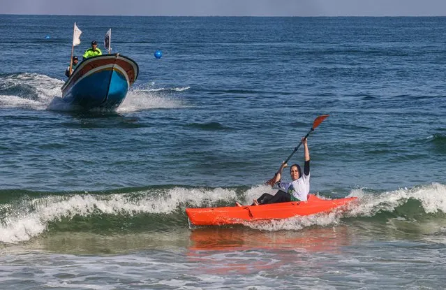 A Palestinian woman takes part in a local canoeing chanpionship, off the coast of Gaza City, on September 11, 2022. (Photo by Said Khatib/AFP Photo)