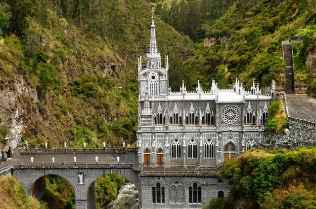 Located near the border of Colombia and Ecuador, the Las Lajas Sanctuary is undoubtedly one of the most beautiful basilicas in the world. The precarious gothic revival structure is built into the canyon of the Guaitara River, connecting the two banks. The church was constructed in honor of two legendary miracles, and its miraculous location surely pays tribute to these origins. (Photo by Rchphoto via Getty Images)