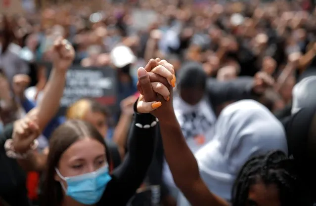 People hold hands during a protest against police brutality and the death in Minneapolis police custody of George Floyd, in Nantes, France, June 8, 2020. (Photo by Stephane Mahe/Reuters)