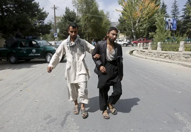 An injured Afghan man is assisted by a relative after he was wounded by a suicide bomb attack at the Paghman district, north of Kabul, Afghanistan September 16, 2015. At least 4 people were killed and 41 others were wounded in the attack, according to Kabul's police chief Abdul Rahman Rahimi. (Photo by Omar Sobhani/Reuters)