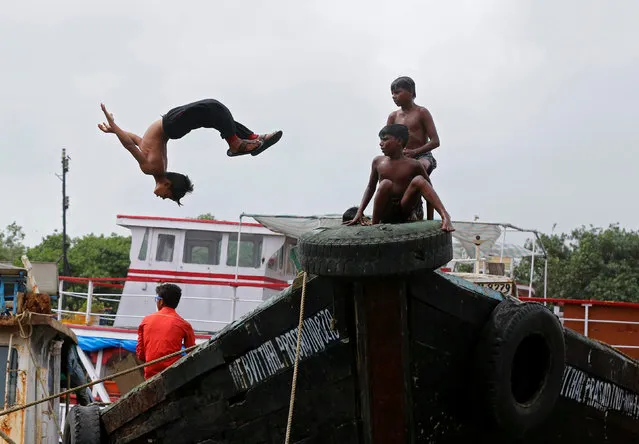 A boy dives off from a boat under maintenance in a dry dock in Mumbai, India, August 22, 2016. (Photo by Shailesh Andrade/Reuters)