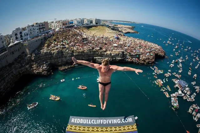 In this handout image provided by Red Bull, Artem Silchenko of Russia dives from the 27 metre platform during the fifth stop of the Red Bull Cliff Diving World Series, Polignano a Mare, Italy. (Photo by Romina Amato/Red Bull via Getty Images)