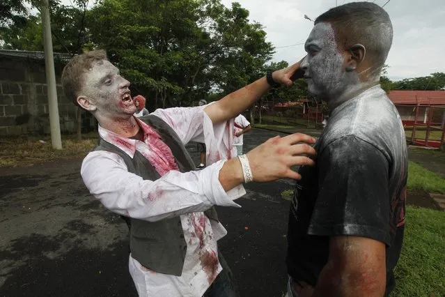 People dressed as zombies take part in a zombie race to raise funds for children with cancer at the child Hospital Manuel de Jesus Rivera in Managua October 19, 2014. (Photo by Oswaldo Rivas/Reuters)